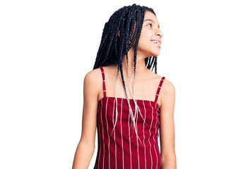 Naklejka premium Cute african american girl wearing casual clothes looking away to side with smile on face, natural expression. laughing confident.