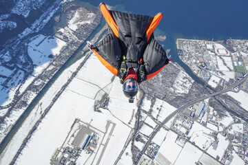 Wingsuit flier glides over Swiss Alps