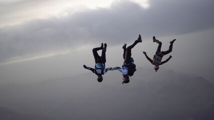 Skydivers perform stunts over Swiss Alps