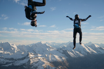 Skydivers perform stunts over Swiss Alps