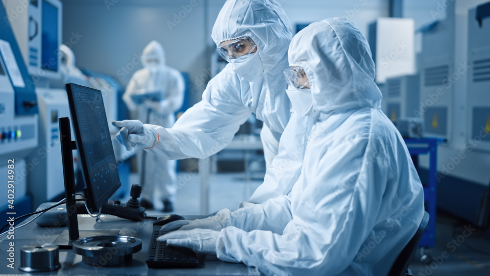 Aufkleber Factory Cleanroom: Engineer and Scientist Wearing Coveralls and Masks Have Discussion, Use Computer Showing Infrastructure System Control. In Background CNC Machinery, Electronics Equipment