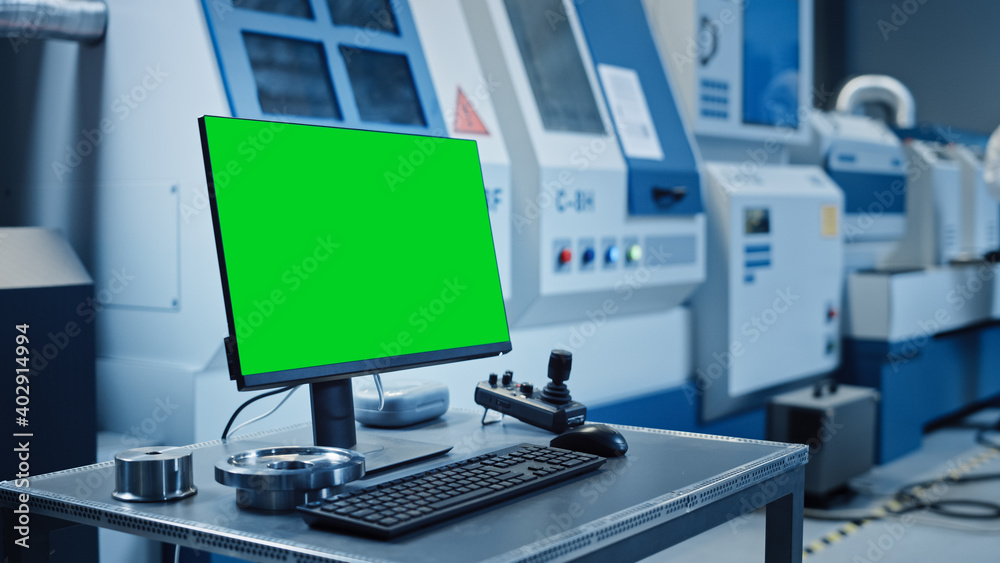 Poster Factory Cleanroom: On the Desk Personal Computer Showing Green Screen Chroma Key Display. In Background CNC Machinery, Professionals Use Robot Arm on Production Line.
