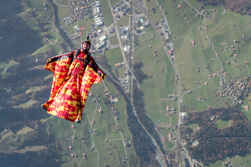 Wingsuit flier glides over Swiss Alps