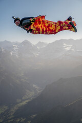 Wingsuit flier glides over Swiss Alps
