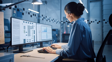 Factory Office: Portrait of Beautiful and Confident Female Industrial Engineer Working on Computer,...