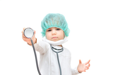Portrait of funny kid playing in the hospital isolated on white. Cute little girl doctor role playing. Adorable child wearing white uniform, mask and stethoscope. Childhood vaccinations.