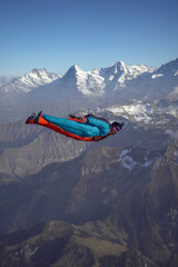 Wingsuit flier glides over Swiss Alps