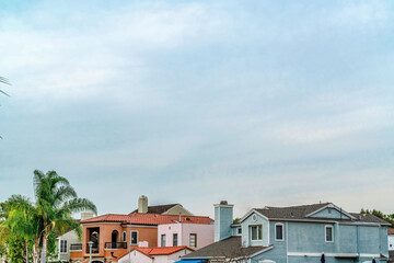 Fototapeta na wymiar Cloudy sky over houses in scenic coastal neighborhood of Long Beach California
