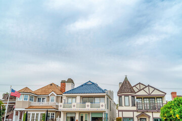 Stylish houses with front balconies against cloudy sky in Long Beach California