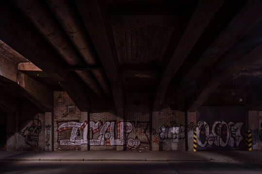 Dark empty dirty grunge underground concrete tunel with a road during mystic night with blue street lights