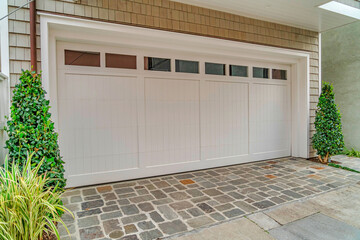 Attached garage of house in Long Beach California with glass panes on white door