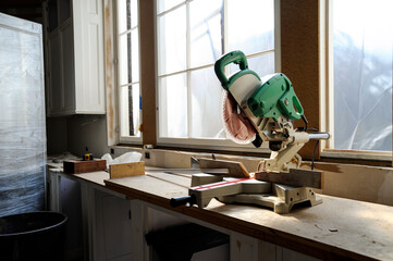 Miter saw sitting on new cabinets