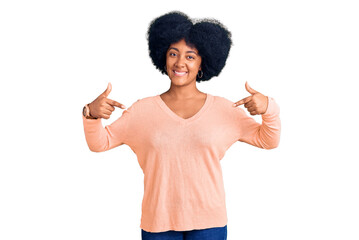 Young african american girl wearing casual clothes looking confident with smile on face, pointing oneself with fingers proud and happy.