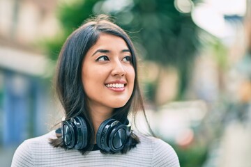 Young hispanic woman smiling happy walking at the city.