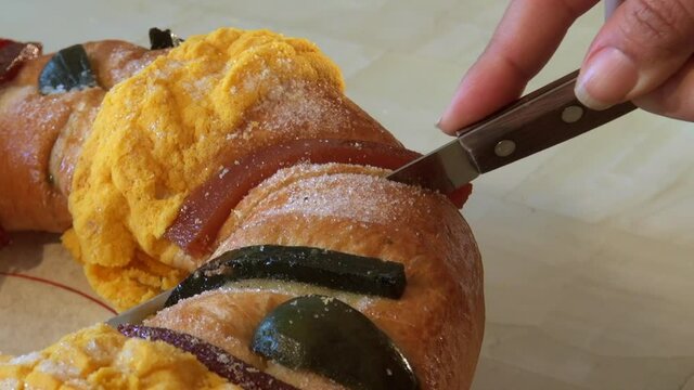 family shares traditional rosca de reyes. Detail of rosca de reyes with typical sweets of the region
