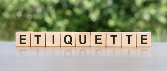 ETIQUETTE word written on wooden blocks. ETIQUETTE text on wooden table for your desing, concept.