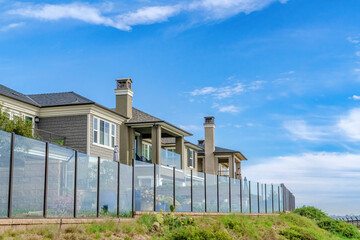 Fototapeta na wymiar Homes with glass fences and scenic waterfront views in Huntington Beach CA
