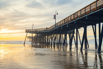Sunset on the beach and pier. An iconic California wooden pier at 1, 370 feet long in the heart of Pismo Beach city in Central California coast.