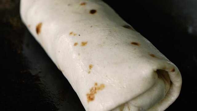 cooking traditional mexican burrito on the grill