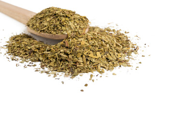 Dried leaves of yerba mate tea on wooden spoon isolated on white background. nutrition. Traditional tea in South-America.