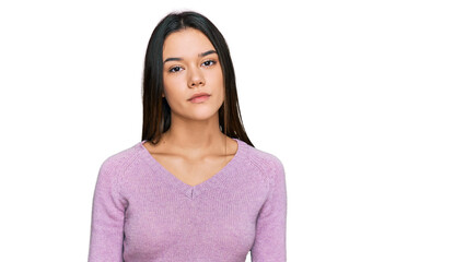 Young hispanic girl wearing casual clothes relaxed with serious expression on face. simple and natural looking at the camera.