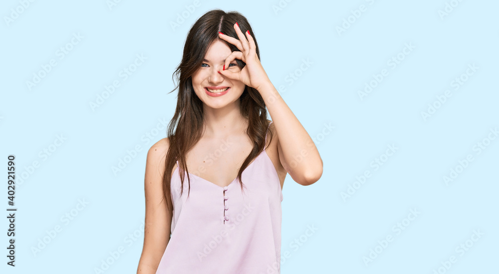 Sticker young beautiful caucasian girl wearing casual clothes doing ok gesture with hand smiling, eye lookin