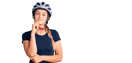 Beautiful caucasian woman wearing bike helmet looking confident at the camera with smile with...