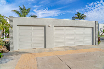 Detached garage with flat roof two doors and gray wall in Huntington Beach CA