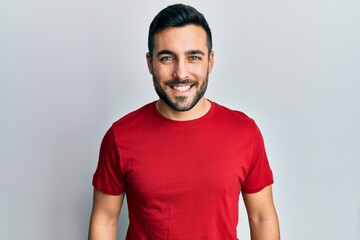 Young hispanic man wearing casual clothes with a happy and cool smile on face. lucky person.
