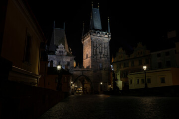 .bridge towers on Charles Bridge and street lights at night in Prague in the Czech Republic
