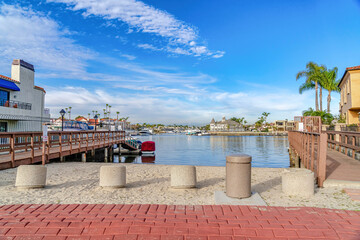 Scenic sea with boat docks under vibrant blue sky in Huntington Beach California