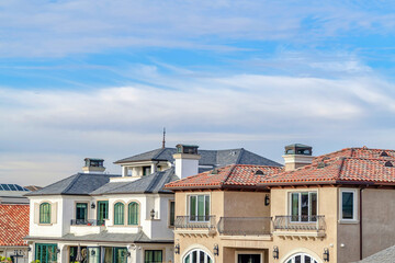 Fototapeta na wymiar Homes with balconies in Huntington Beach California against clouds and blue sky