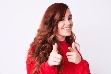 Young beautiful woman wearing casual clothes pointing fingers to camera with happy and funny face. good energy and vibes.