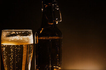 macro beer bottle and a glass of beer on a dark