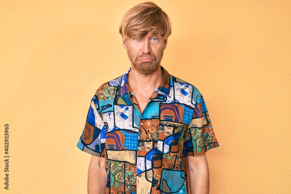 Sticker Young blond man wearing summer shirt depressed and worry for distress, crying angry and afraid. sad expression.