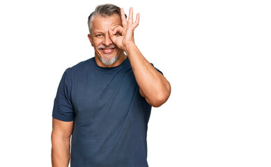 Middle age grey-haired man wearing casual clothes doing ok gesture with hand smiling, eye looking through fingers with happy face.