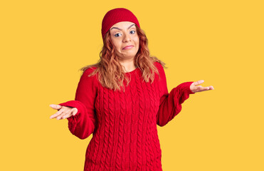Young latin woman wearing casual clothes clueless and confused expression with arms and hands...