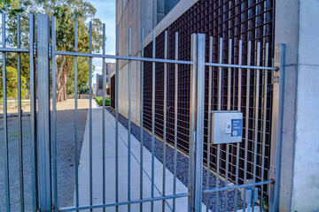 Closed metal gate at the entrance to school campus in San Diego California