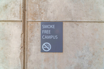 Smoke Free Campus sign on exterior wall of school building in San Diego CA