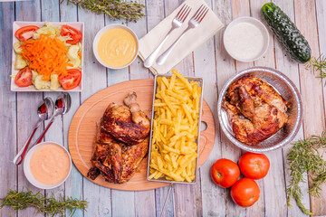 overhead shot of roast chicken and sauces