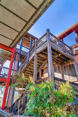 Wood building with stairway and balcony against blue sky in San Diego California