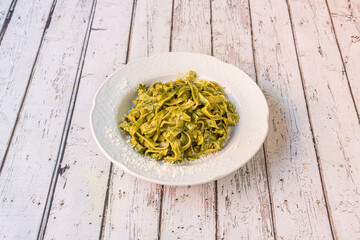 pesto pasta dish on white table