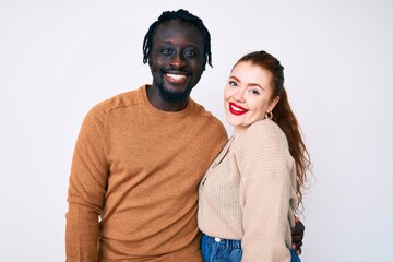 Interracial couple wearing casual clothes with a happy and cool smile on face. lucky person.