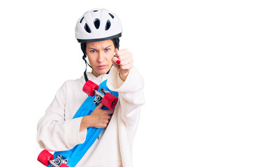 Beautiful brunette young woman wearing safety helmet and skate annoyed and frustrated shouting with anger, yelling crazy with anger and hand raised