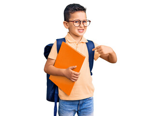 Little cute boy kid wearing school bag and holding book pointing finger to one self smiling happy and proud