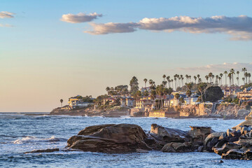 Ocean waves crashing against huge rocks at the coastline of San Diego California