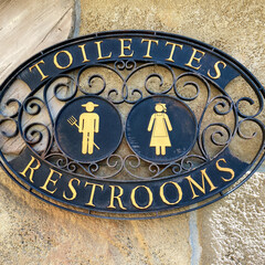 A sign signifying a restroom entrance.