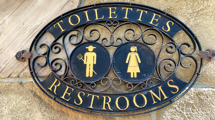 A sign signifying a restroom entrance.