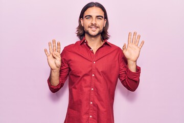 Young handsome man wearing business clothes showing and pointing up with fingers number nine while...