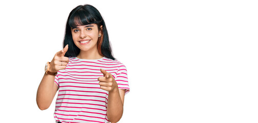 Young hispanic girl wearing casual clothes pointing fingers to camera with happy and funny face. good energy and vibes.